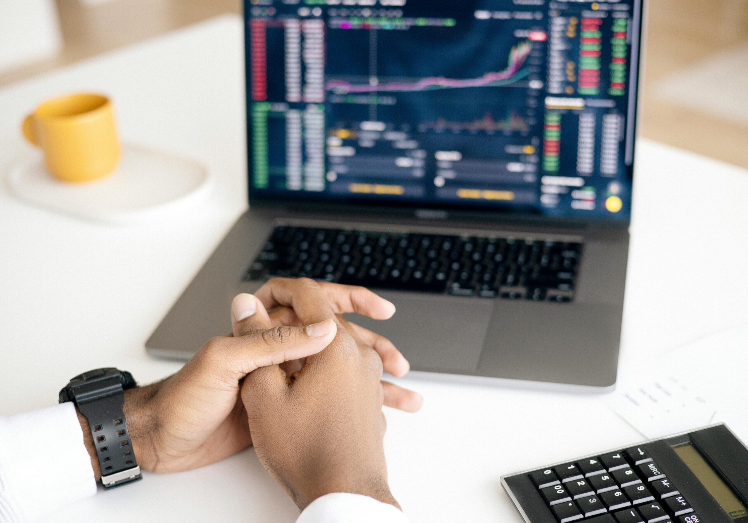 pexels-anna-nekrashevich-6801647 laptop showing stocks, crossed hands